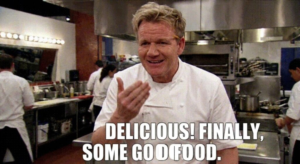 A GIF of Gordon Ramsay smiling and saying "Delicious! Finally, some good food."